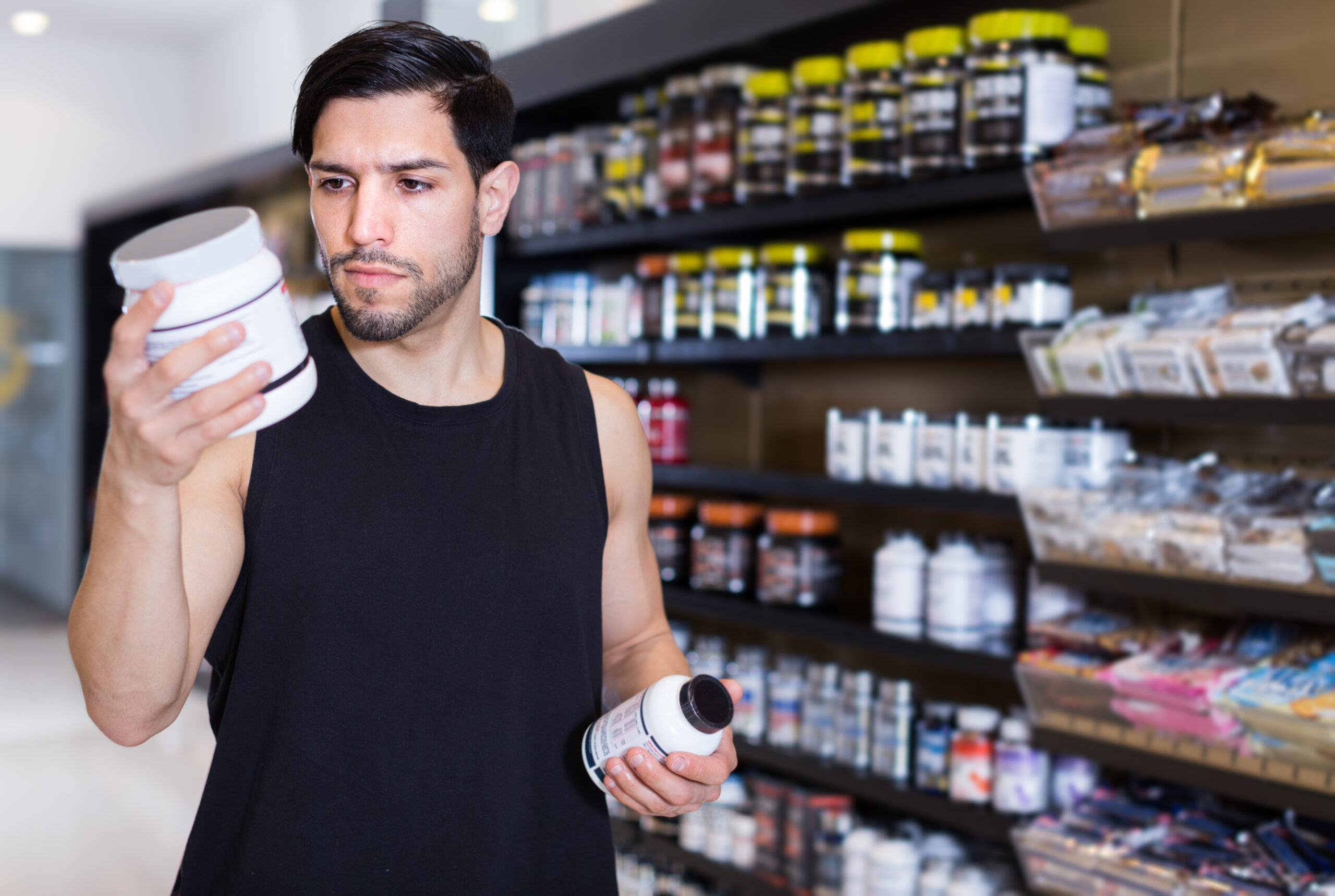 Man looking sport dietary supplements in store